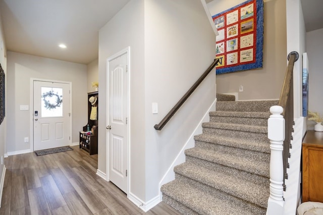 entrance foyer featuring recessed lighting, stairs, baseboards, and wood finished floors