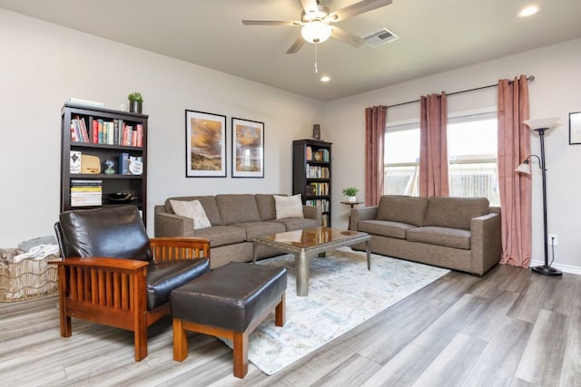 living area featuring light wood-type flooring, visible vents, recessed lighting, baseboards, and ceiling fan