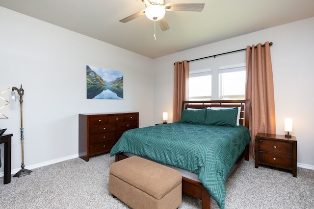 bedroom featuring ceiling fan, baseboards, and carpet