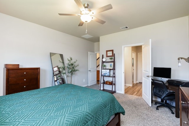 carpeted bedroom with a ceiling fan, visible vents, and baseboards