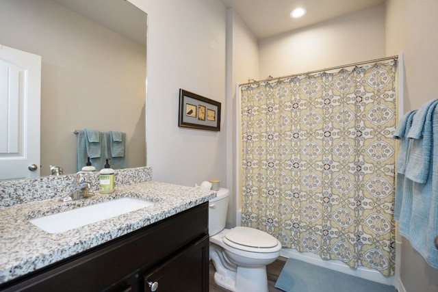 bathroom with vanity, shower / tub combo, toilet, and recessed lighting