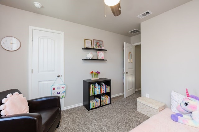 interior space featuring visible vents, carpet floors, baseboards, and a ceiling fan