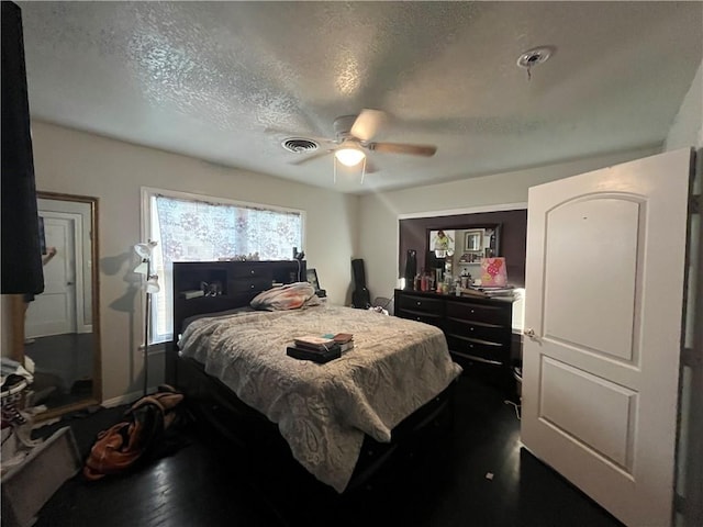 1253 Logan Ave, Corpus Christi, TX 78404 - bedroom with a textured ceiling, dark wood-type flooring, a ceiling fan, and baseboards