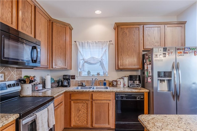 2122 Halcon St, Corpus Christi, TX 78414 - kitchen featuring light stone countertops, black appliances, recessed lighting, a sink, and brown cabinets