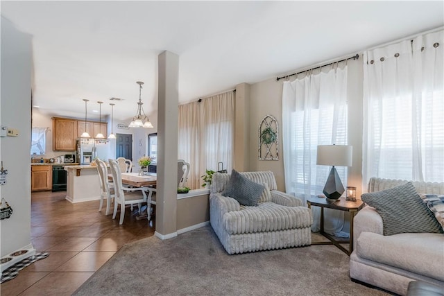 2122 Halcon St, Corpus Christi, TX 78414 - living area featuring tile patterned floors, baseboards, and an inviting chandelier