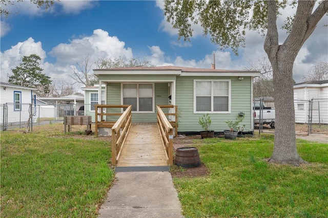 bungalow-style house featuring a front lawn