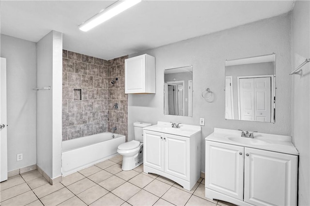 full bathroom featuring vanity, tile patterned floors, toilet, and tiled shower / bath