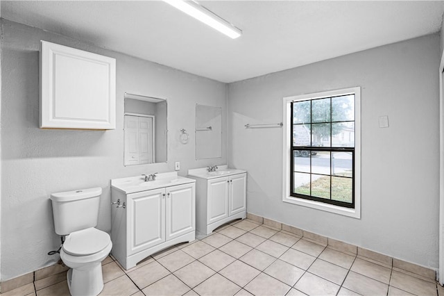 bathroom with tile patterned floors, vanity, and toilet