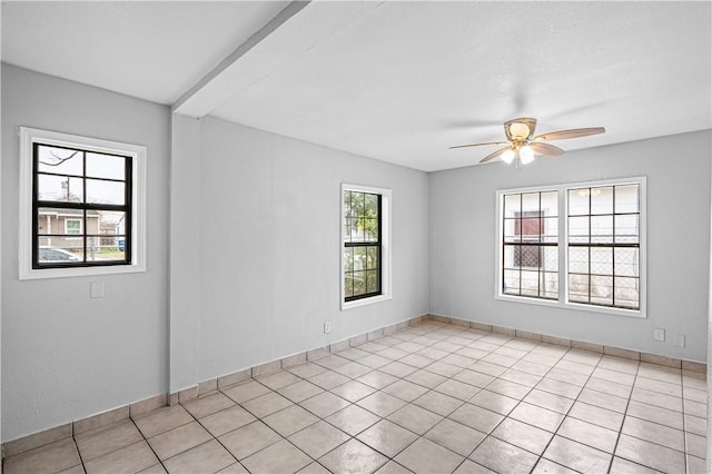 empty room with light tile patterned floors, beam ceiling, and ceiling fan