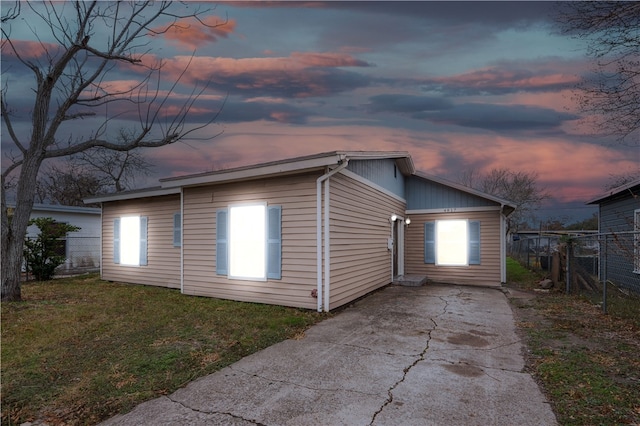 property exterior at dusk with a yard