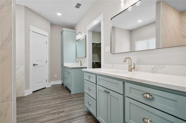 bathroom with hardwood / wood-style floors and vanity