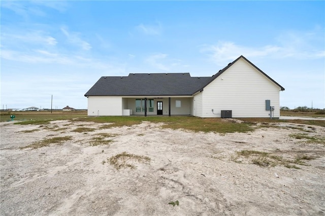 rear view of house featuring central AC