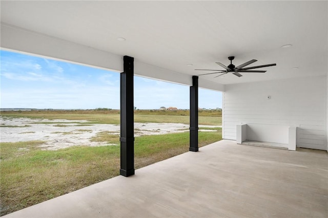 view of patio featuring ceiling fan and a rural view