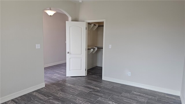 spare room with dark hardwood / wood-style flooring