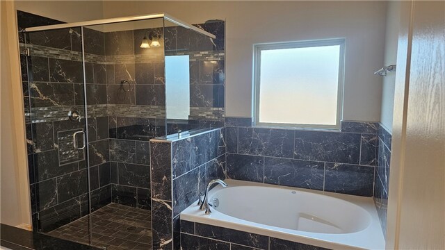 bathroom featuring separate shower and tub