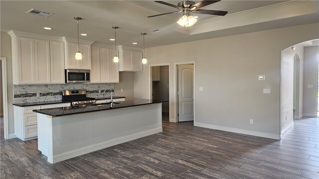 kitchen featuring white cabinets, appliances with stainless steel finishes, sink, and an island with sink