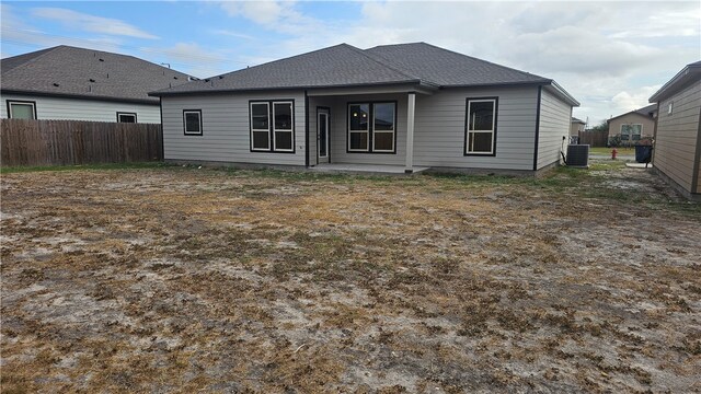 rear view of property featuring central AC unit