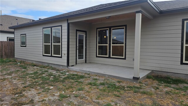 back of property with a patio