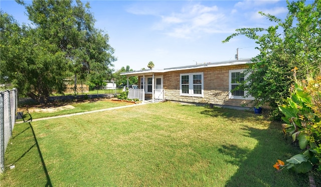 rear view of house with a yard