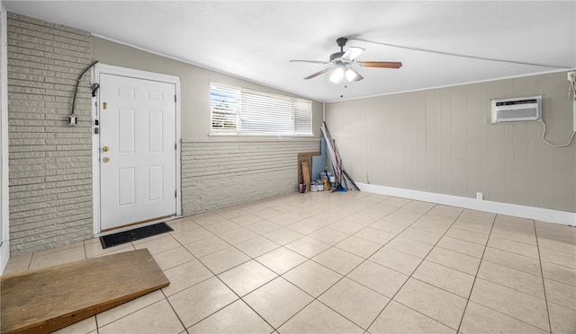 tiled entrance foyer featuring a wall mounted AC, brick wall, wooden walls, and ceiling fan