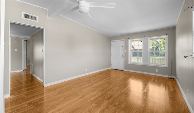 unfurnished room featuring light hardwood / wood-style flooring, beamed ceiling, and ceiling fan