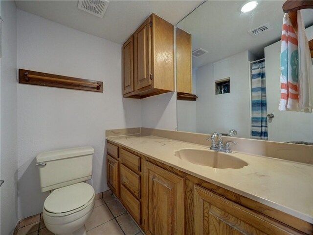 5973 State Highway 361 Unit 433, Port Aransas, TX 78373 - bathroom with toilet, vanity, tile patterned flooring, and curtained shower