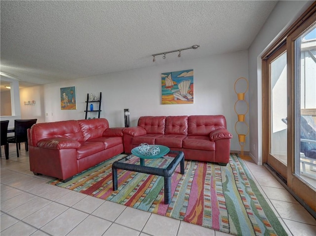 5973 State Highway 361 Unit 433, Port Aransas, TX 78373 - tiled living room featuring a textured ceiling, healthy amount of natural light, and rail lighting