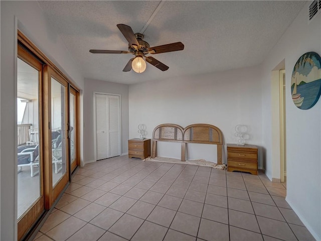 5973 State Highway 361 Unit 433, Port Aransas, TX 78373 - spare room with a textured ceiling, a ceiling fan, light tile patterned flooring, and baseboards