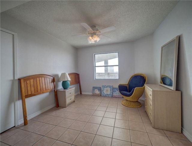 5973 State Highway 361 Unit 433, Port Aransas, TX 78373 - unfurnished room featuring a ceiling fan, a textured ceiling, light tile patterned floors, and baseboards