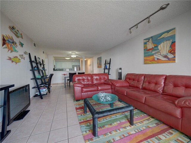 5973 State Highway 361 Unit 433, Port Aransas, TX 78373 - living room featuring a textured ceiling, light tile patterned floors, ceiling fan, and rail lighting