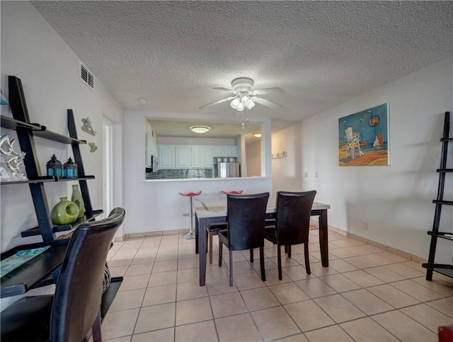 5973 State Highway 361 Unit 433, Port Aransas, TX 78373 - dining space featuring ceiling fan, a textured ceiling, and light tile patterned flooring
