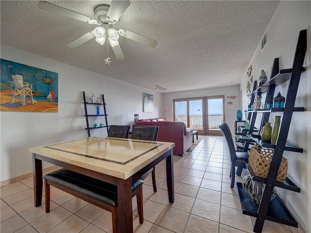 5973 State Highway 361 Unit 433, Port Aransas, TX 78373 - dining space featuring a textured ceiling, light tile patterned floors, and ceiling fan
