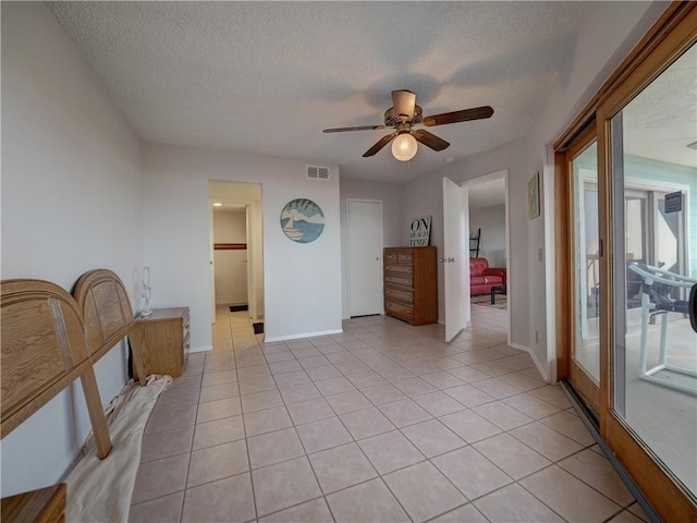 5973 State Highway 361 Unit 433, Port Aransas, TX 78373 - empty room with ceiling fan, baseboards, light tile patterned flooring, and a textured ceiling