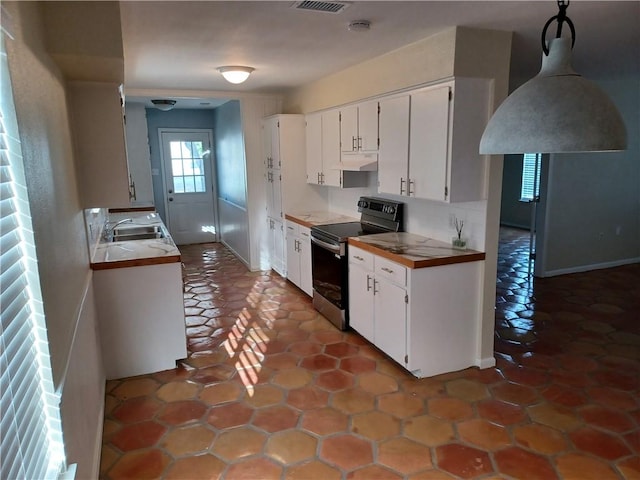 kitchen featuring stainless steel electric stove, white cabinetry, and sink