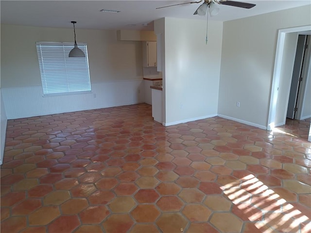 unfurnished living room with ceiling fan