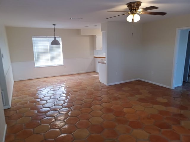 unfurnished dining area featuring ceiling fan