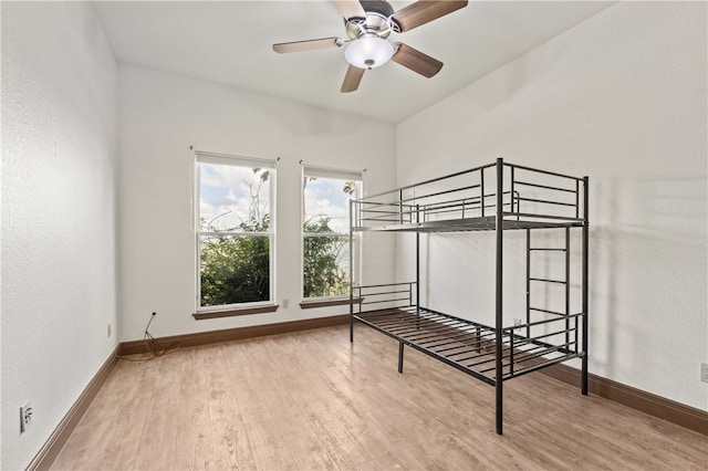 unfurnished bedroom featuring wood-type flooring and ceiling fan