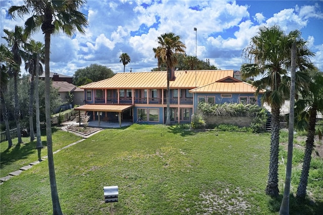 rear view of house featuring a lawn