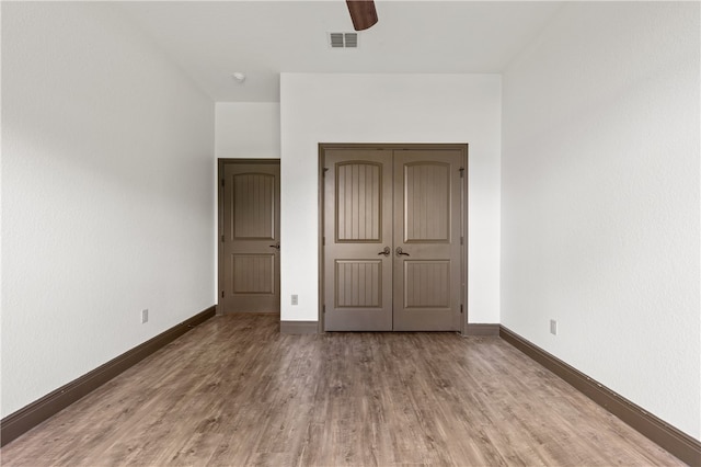 unfurnished bedroom with a closet, ceiling fan, and light hardwood / wood-style floors