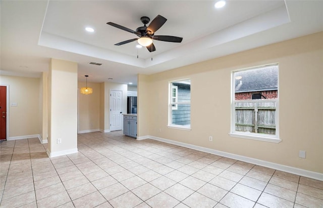 329 Yorktown Blvd, Corpus Christi, TX 78418 - spare room featuring a raised ceiling, ceiling fan, recessed lighting, light tile patterned flooring, and baseboards