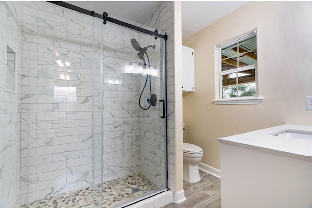 329 Yorktown Blvd, Corpus Christi, TX 78418 - full bathroom with toilet, a stall shower, vanity, and baseboards