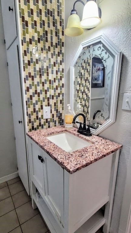 bathroom featuring vanity, tile patterned floors, and backsplash