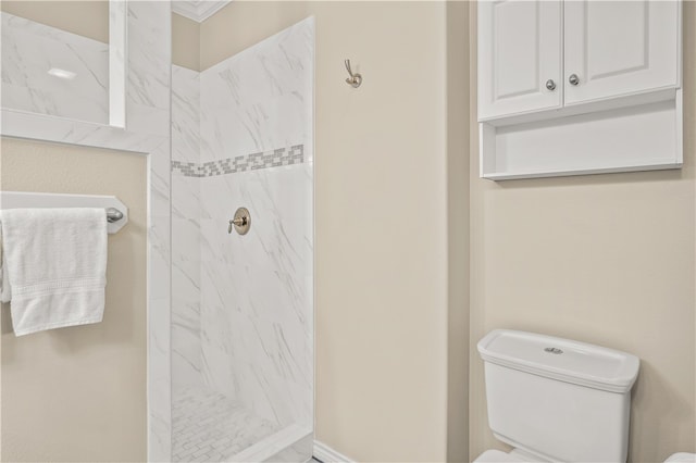 bathroom with tiled shower and toilet