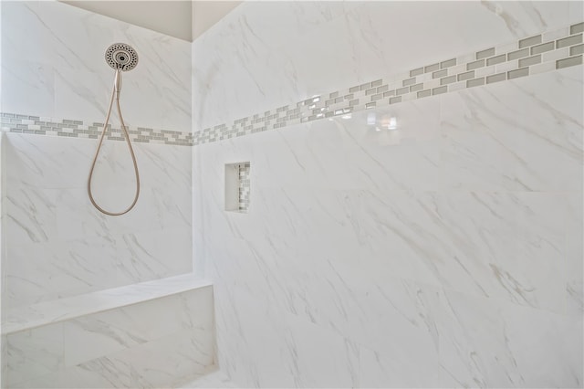 room details featuring a tile shower