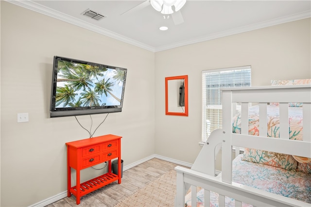 bedroom with ceiling fan, multiple windows, light wood-type flooring, and crown molding