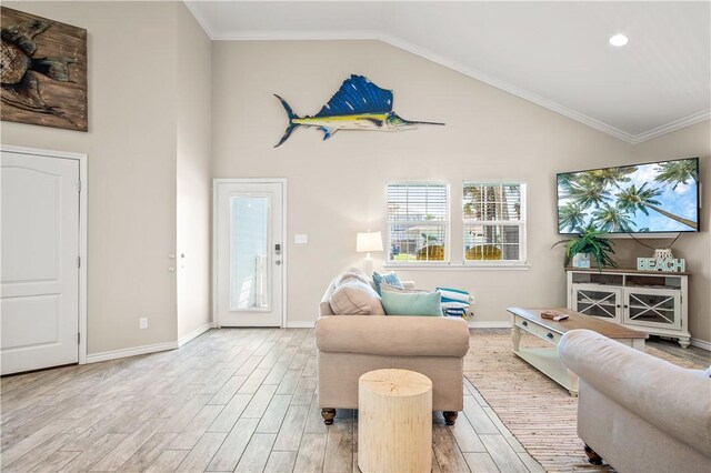623 Sandkey Dr, Port Aransas, TX 78373 - living room featuring light wood-style flooring, baseboards, high vaulted ceiling, recessed lighting, and crown molding