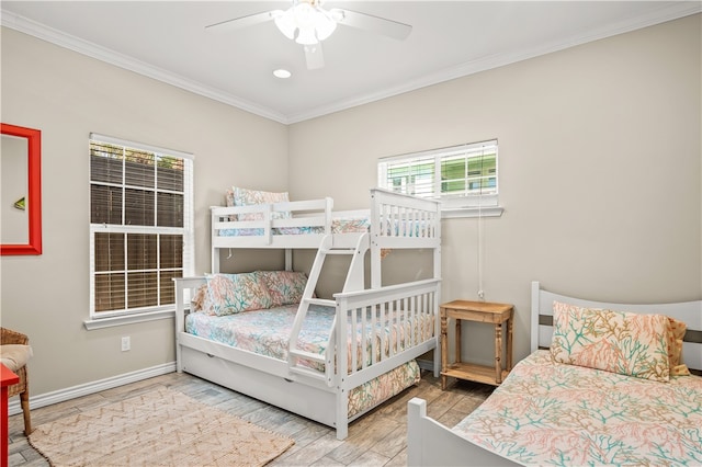 bedroom featuring hardwood / wood-style flooring, ceiling fan, and crown molding