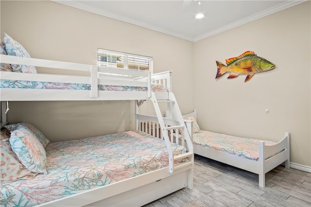 bedroom with ornamental molding and light hardwood / wood-style floors