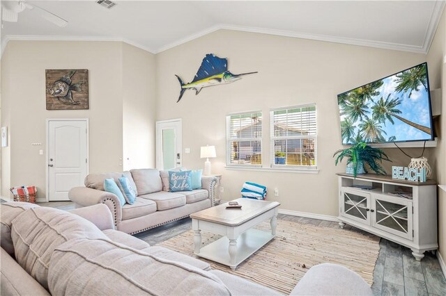 623 Sandkey Dr, Port Aransas, TX 78373 - living room with wood finished floors, baseboards, crown molding, high vaulted ceiling, and ceiling fan