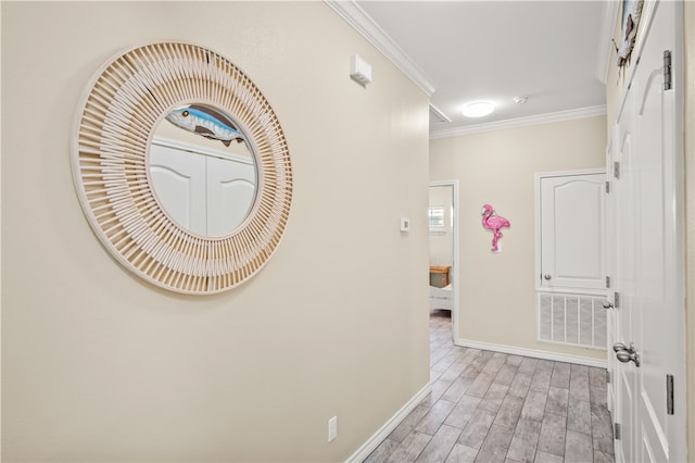 corridor with crown molding and light hardwood / wood-style flooring